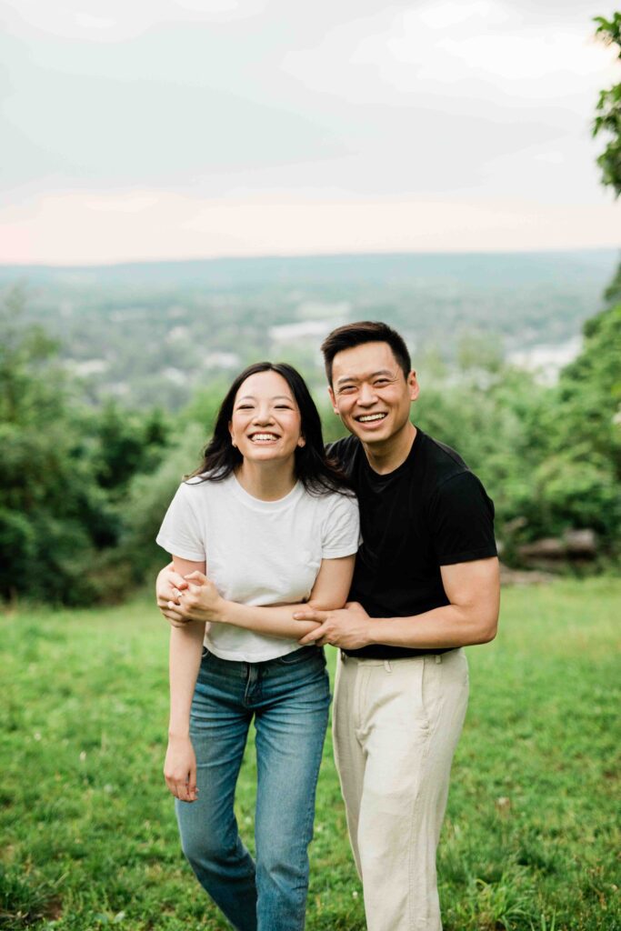 Victoria and Jimmy walking hand-in-hand during their engagement session at Goat Hill Overlook with New Hope engagement photographer
