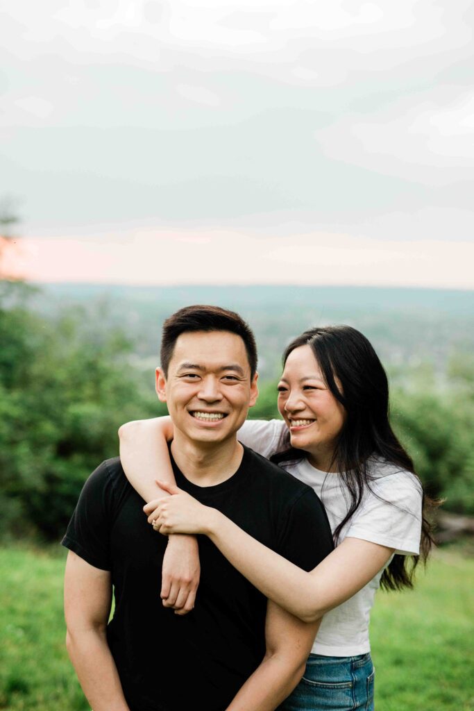 Victoria and Jimmy walking hand-in-hand during their engagement session at Goat Hill Overlook with New Hope engagement photographer