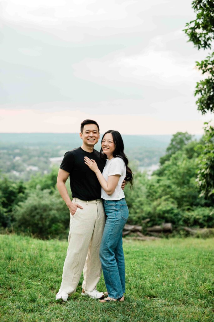Victoria and Jimmy walking hand-in-hand during their engagement session at Goat Hill Overlook with New Hope engagement photographer