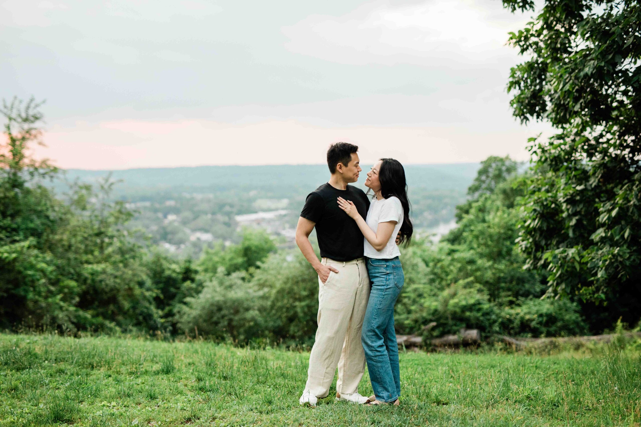 Victoria and Jimmy walking hand-in-hand during their engagement session at Goat Hill Overlook with New Hope engagement photographer
