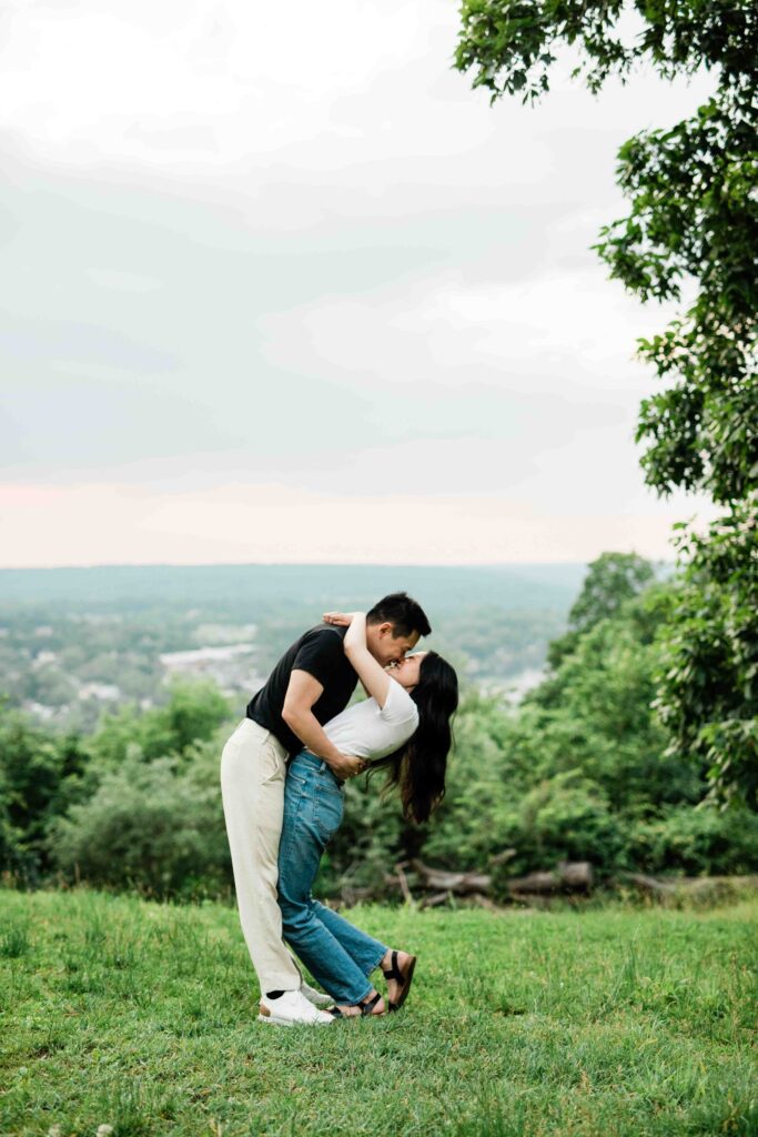 Victoria and Jimmy walking hand-in-hand during their engagement session at Goat Hill Overlook with New Hope engagement photographer
