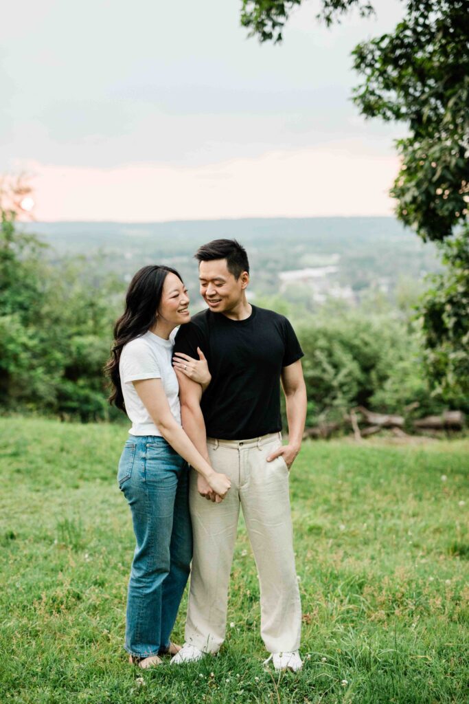 Victoria and Jimmy walking hand-in-hand during their engagement session at Goat Hill Overlook with New Hope engagement photographer