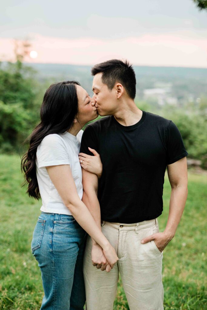 Victoria and Jimmy walking hand-in-hand during their engagement session at Goat Hill Overlook with New Hope engagement photographer