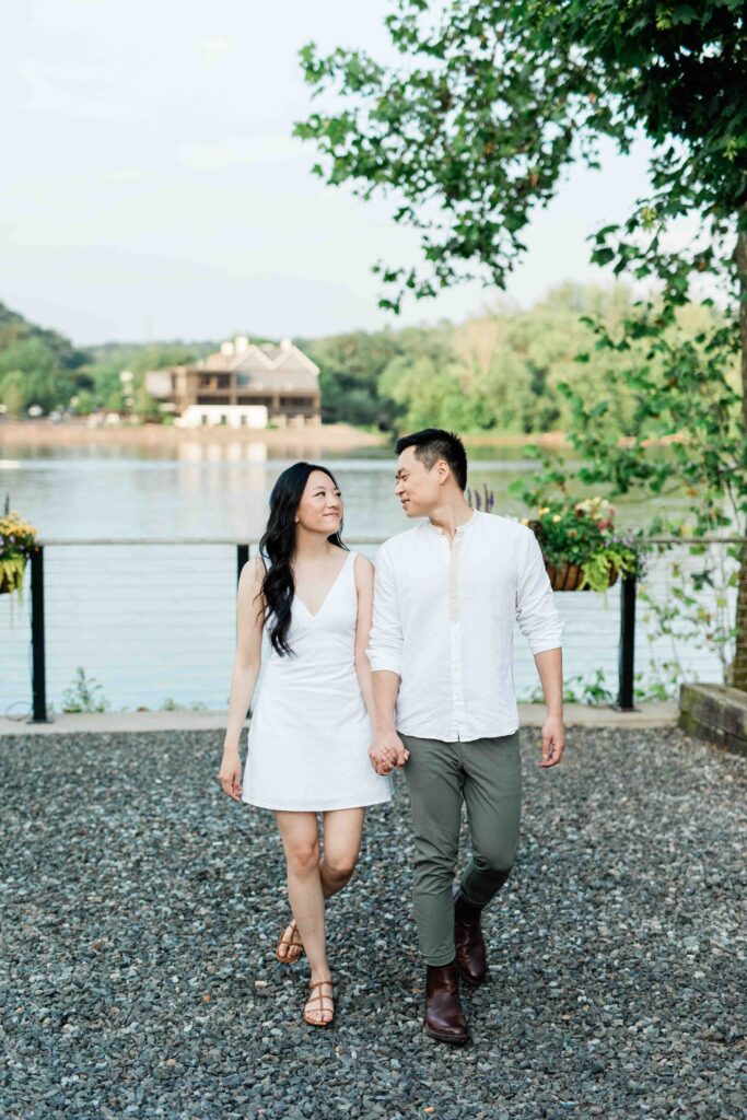 Victoria and Jimmy walking hand-in-hand during their engagement session at Goat Hill Overlook with New Hope engagement photographer