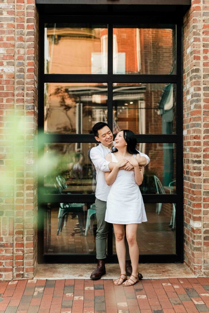 Victoria and Jimmy walking hand-in-hand during their engagement session at Goat Hill Overlook with New Hope engagement photographer