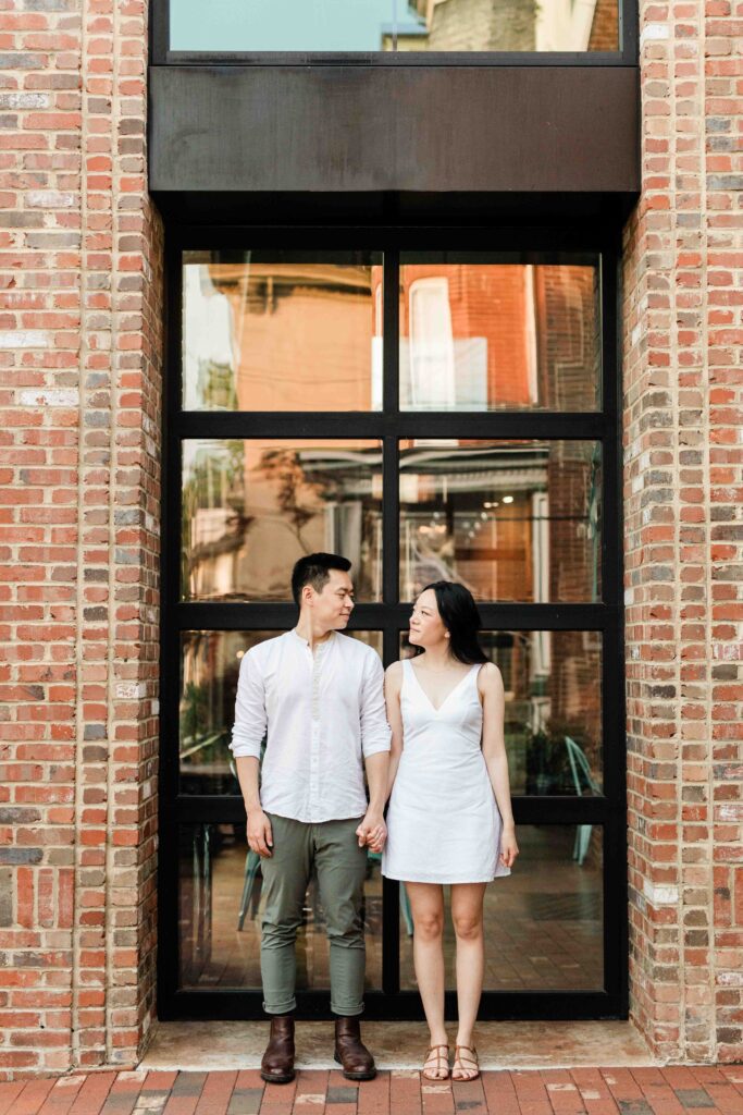 Victoria and Jimmy walking hand-in-hand during their engagement session at Goat Hill Overlook with New Hope engagement photographer