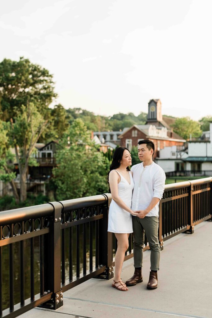 Victoria and Jimmy walking hand-in-hand during their engagement session at Goat Hill Overlook with New Hope engagement photographer