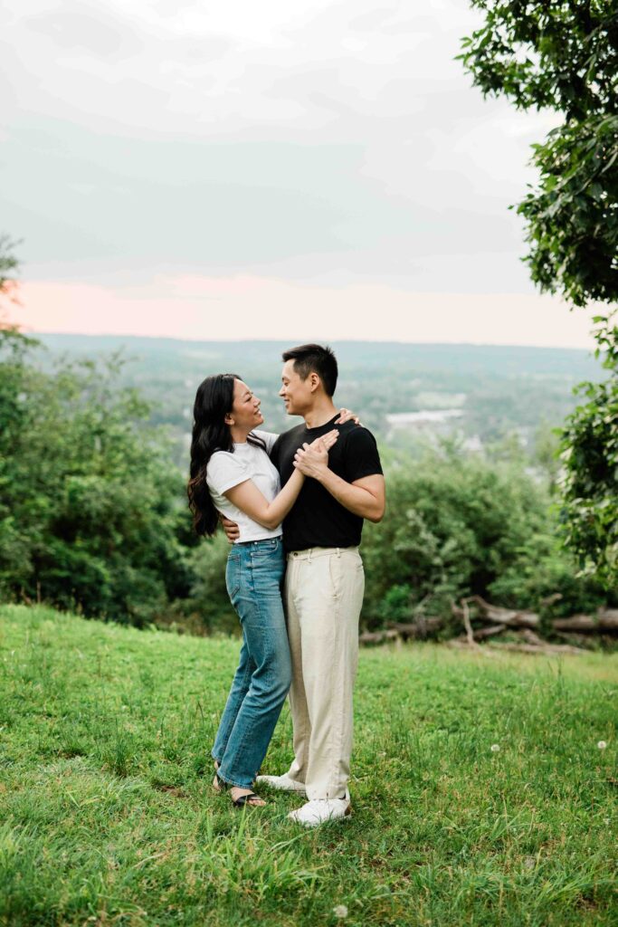 Victoria and Jimmy walking hand-in-hand during their engagement session at Goat Hill Overlook with New Hope engagement photographer